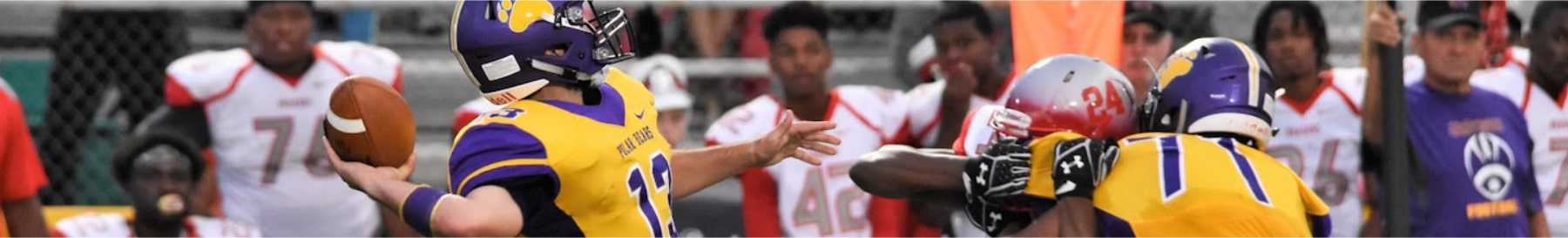 High School Football Team Player Running With the Football With a Larg